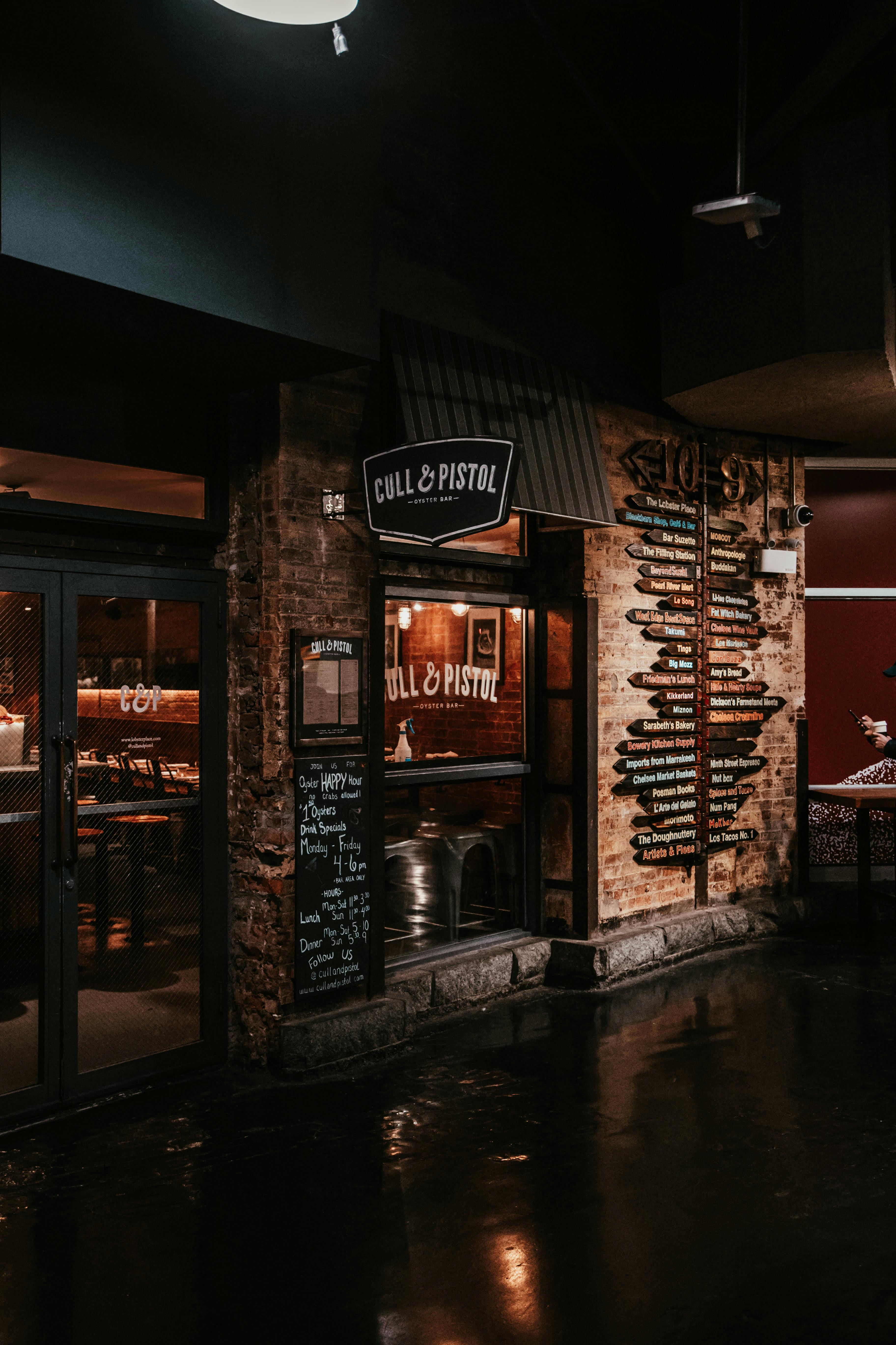 Evening view of Cull & Pistol restaurant exterior with illuminated signage in New York City.