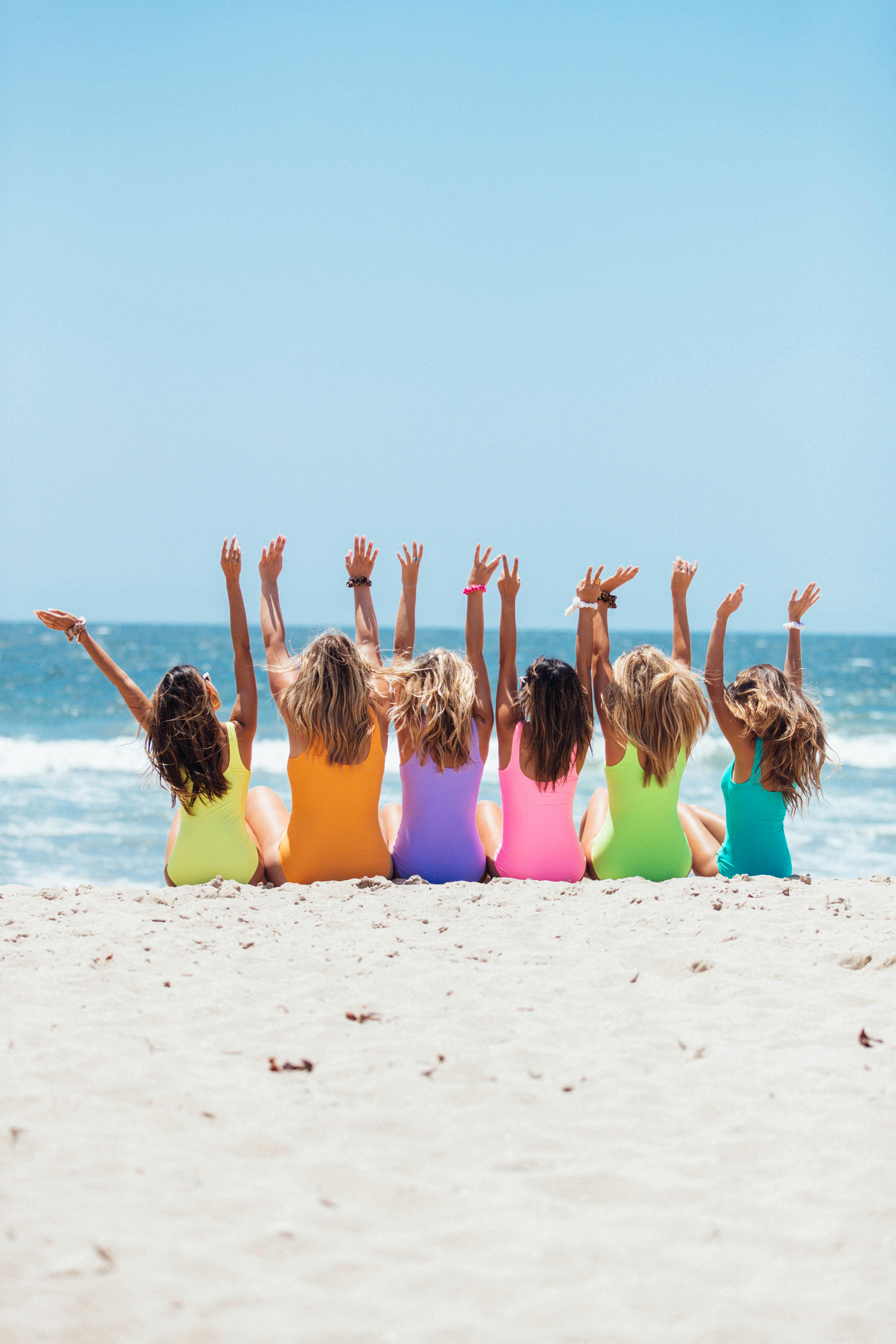 A joyful group of women enjoying a sunny day at Santa Monica Beach.