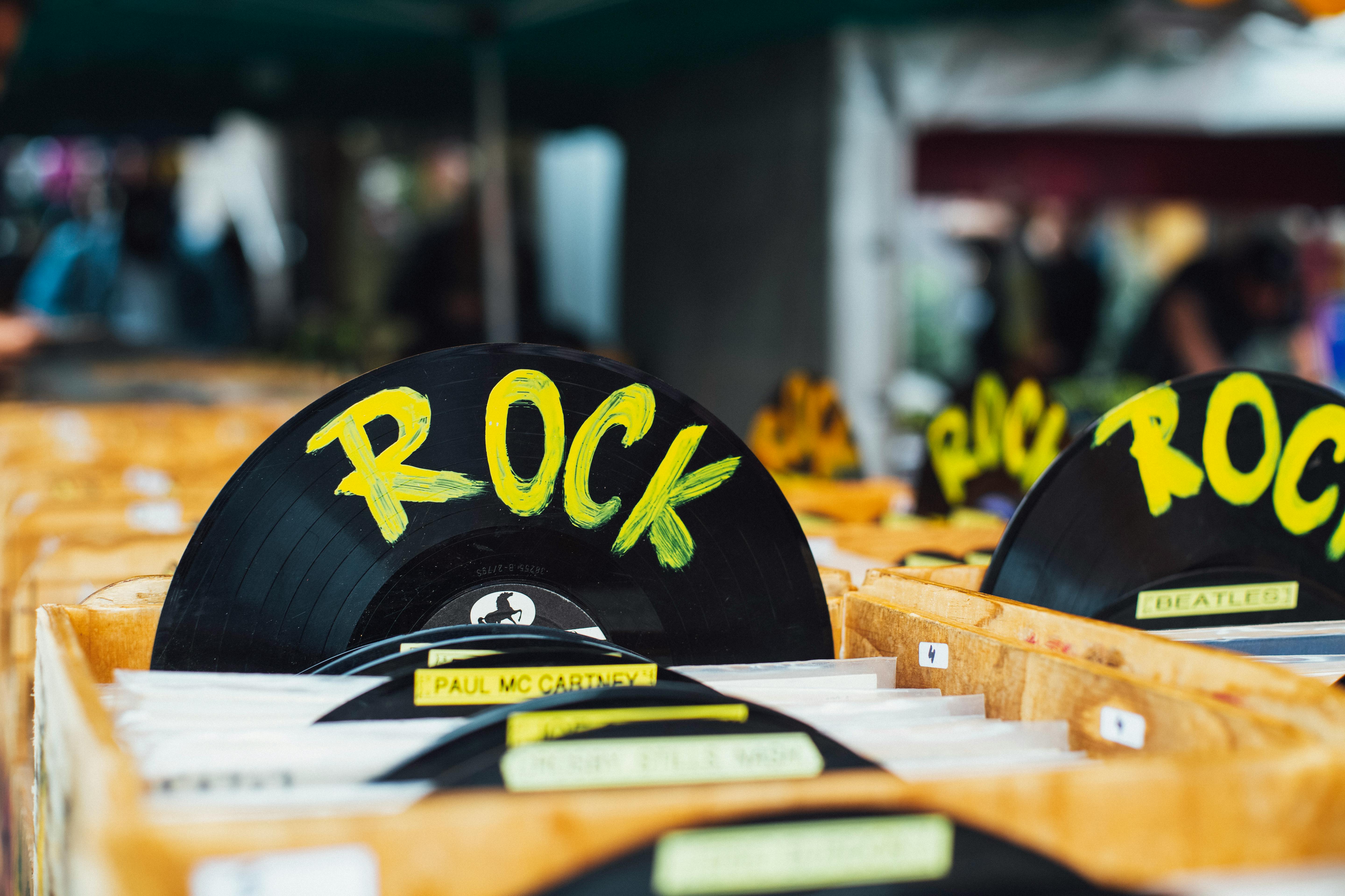 Colorful vinyl records labeled 'Rock' in a vintage music shop, perfect for music enthusiasts.