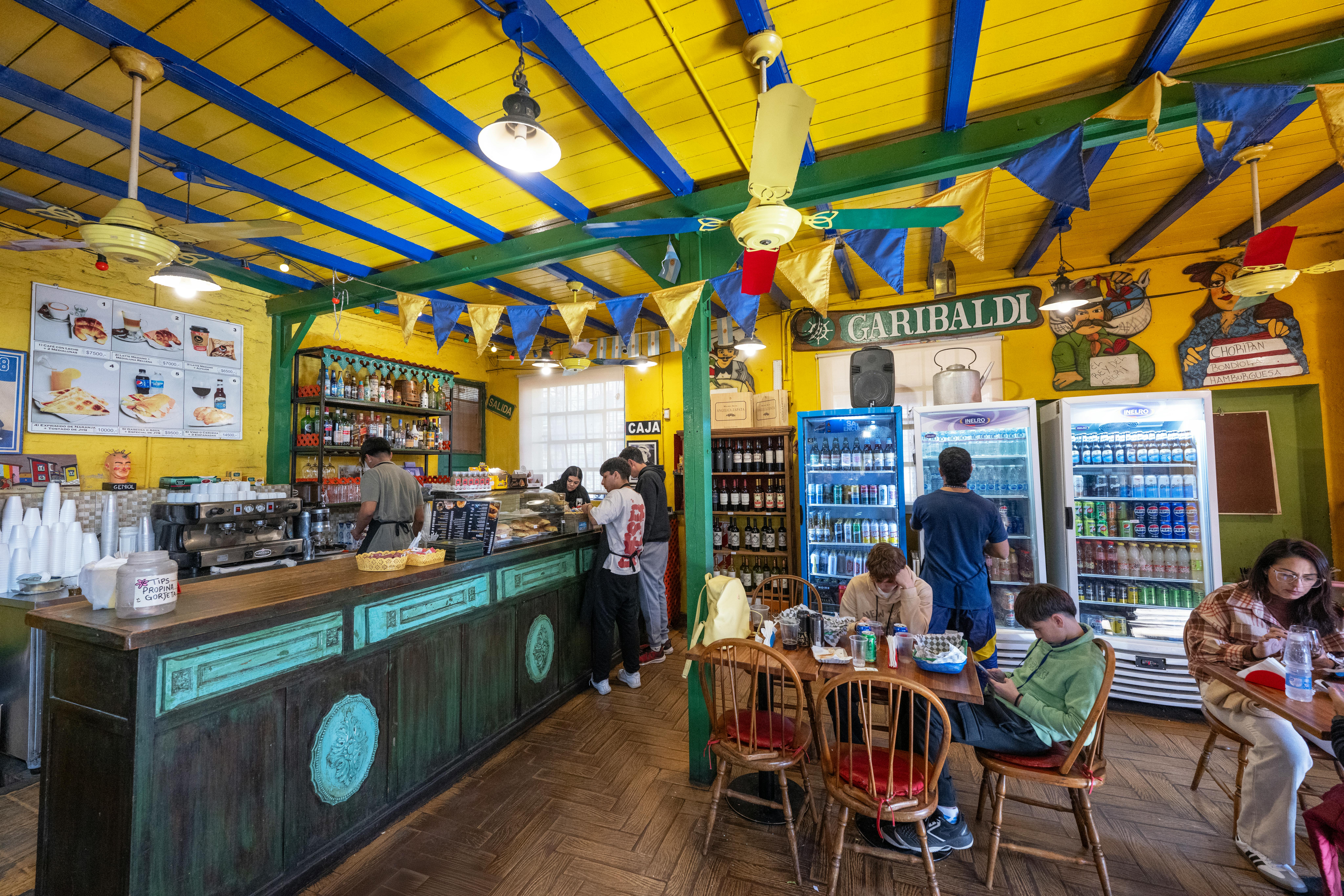 Vibrant café scene in Buenos Aires with people enjoying leisure time and colorful decor.