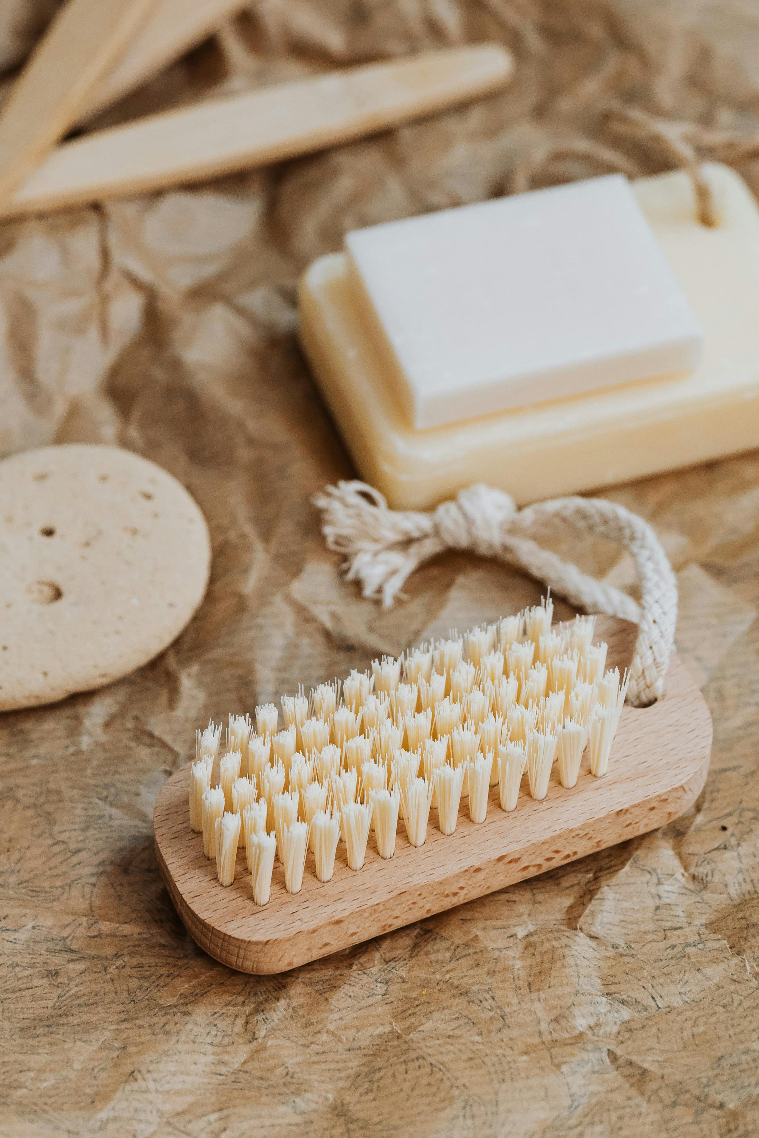 Natural cleaning tools and soap on brown textured background, highlighting sustainability.