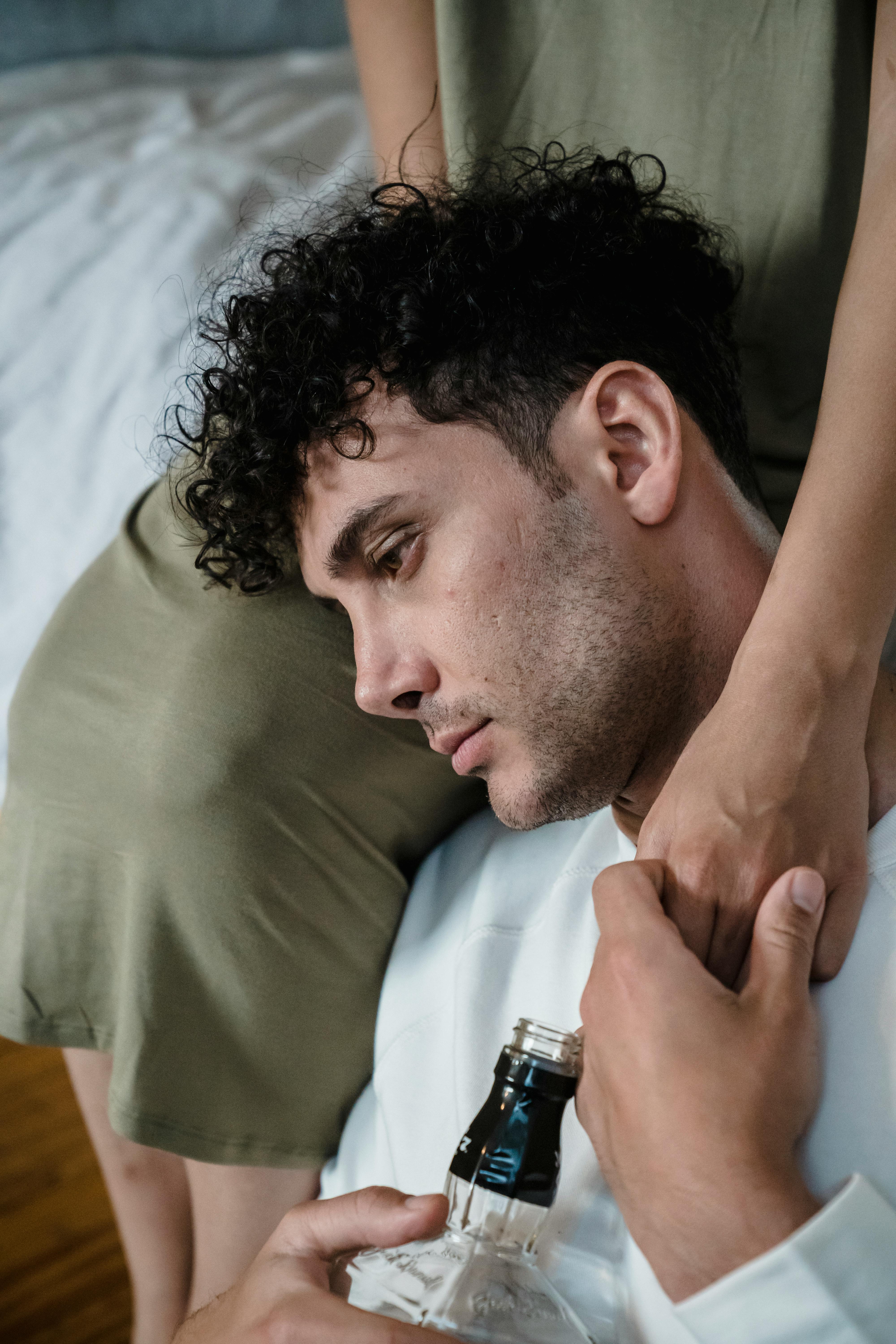 Man leaning on partner, conveying emotional support and deep connection.