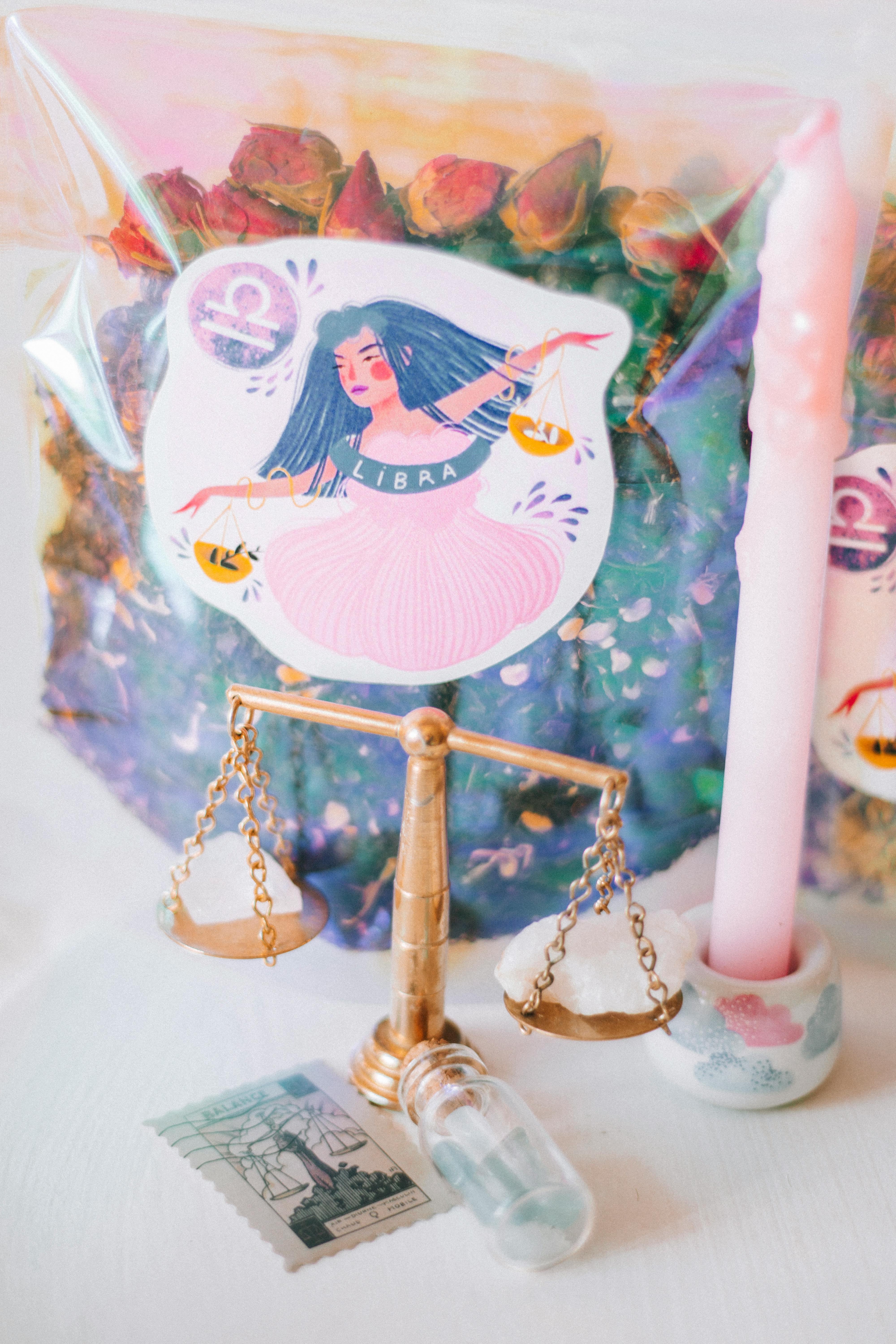 Aesthetic setup featuring Libra zodiac theme, candles, scale, and gemstones for a mystical ambiance.