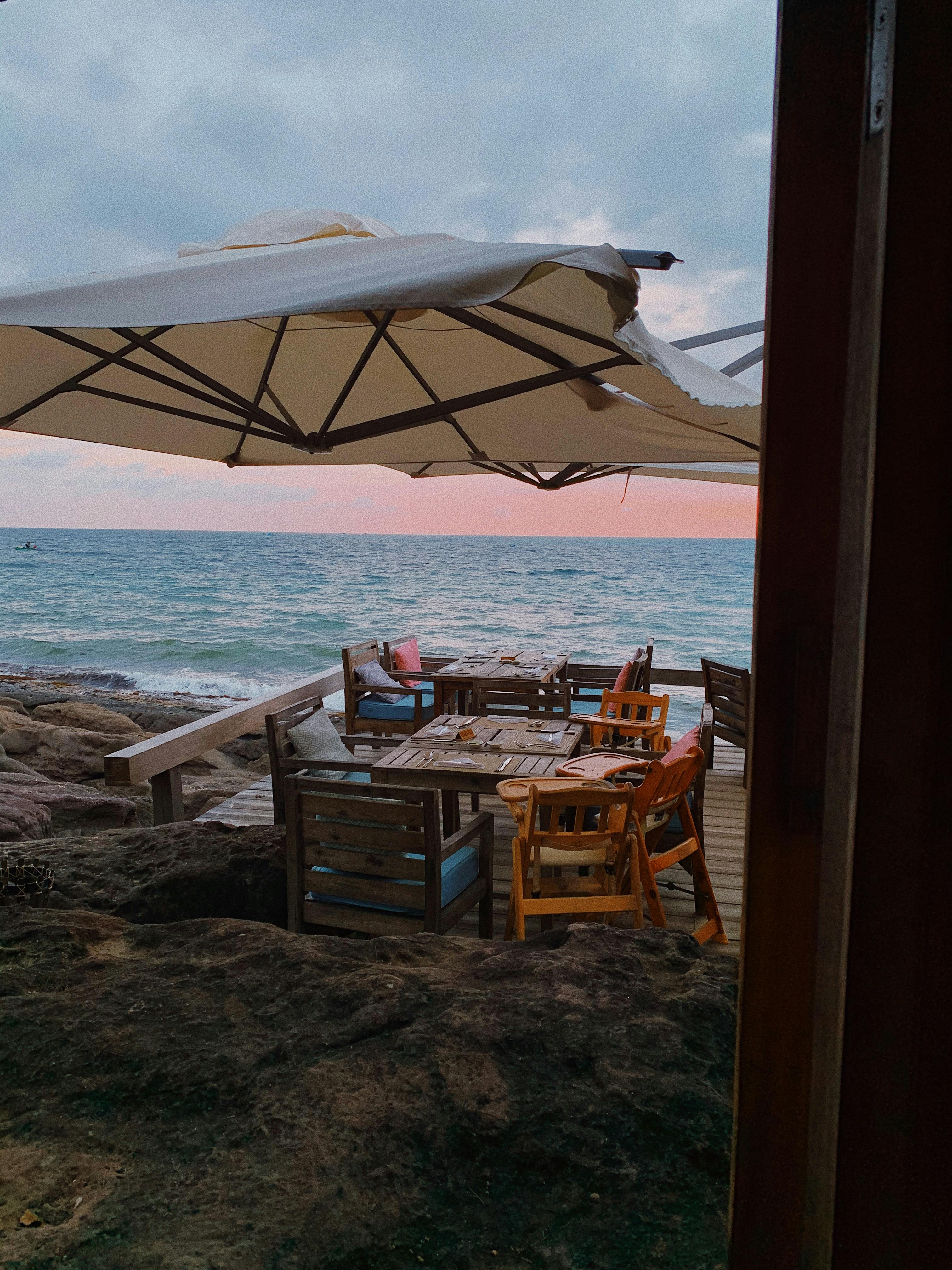 Charming seaside dining area at sunset in Phu Quoc, Vietnam with ocean views.