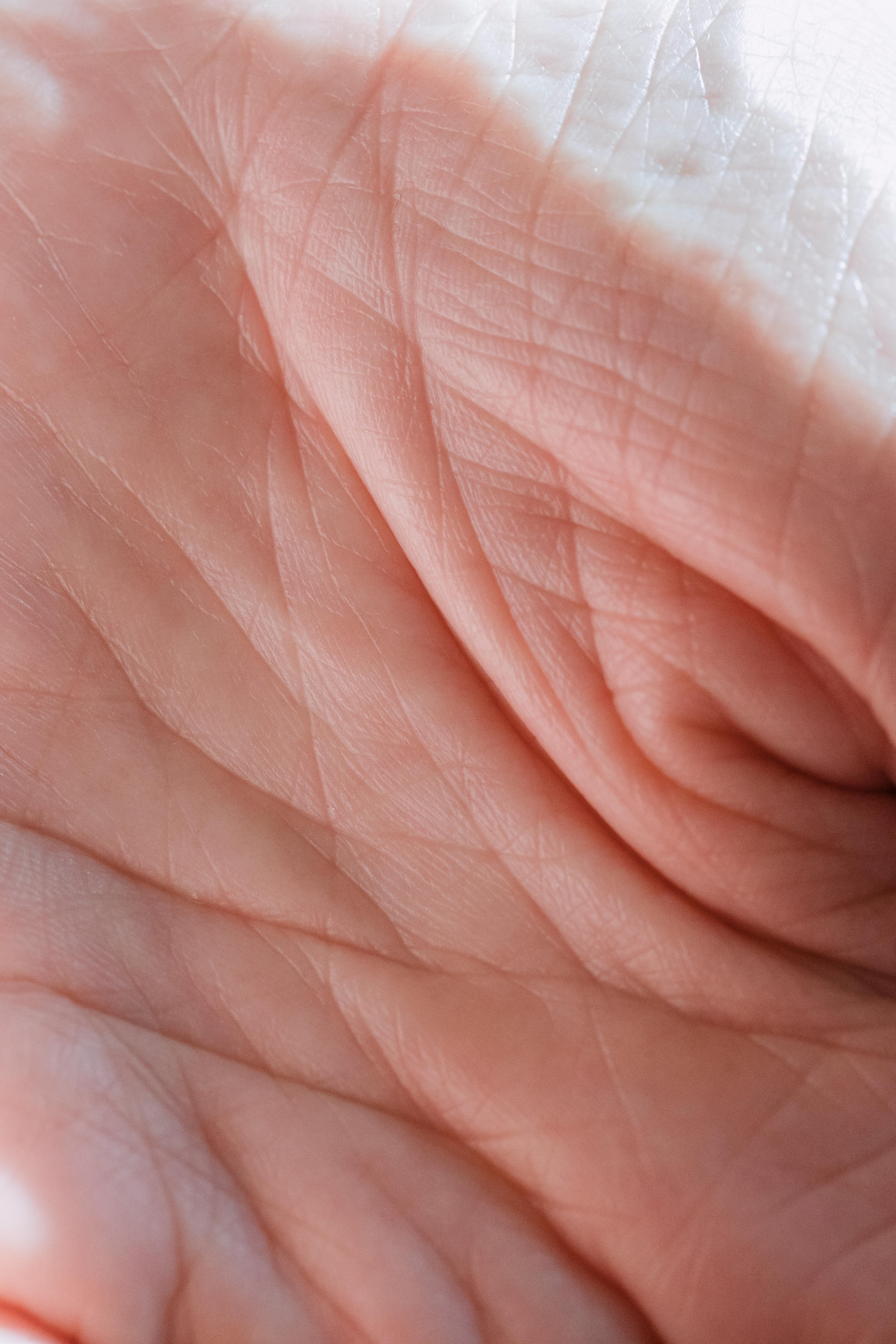 Detailed close-up of a human hand highlighting skin texture and lines.